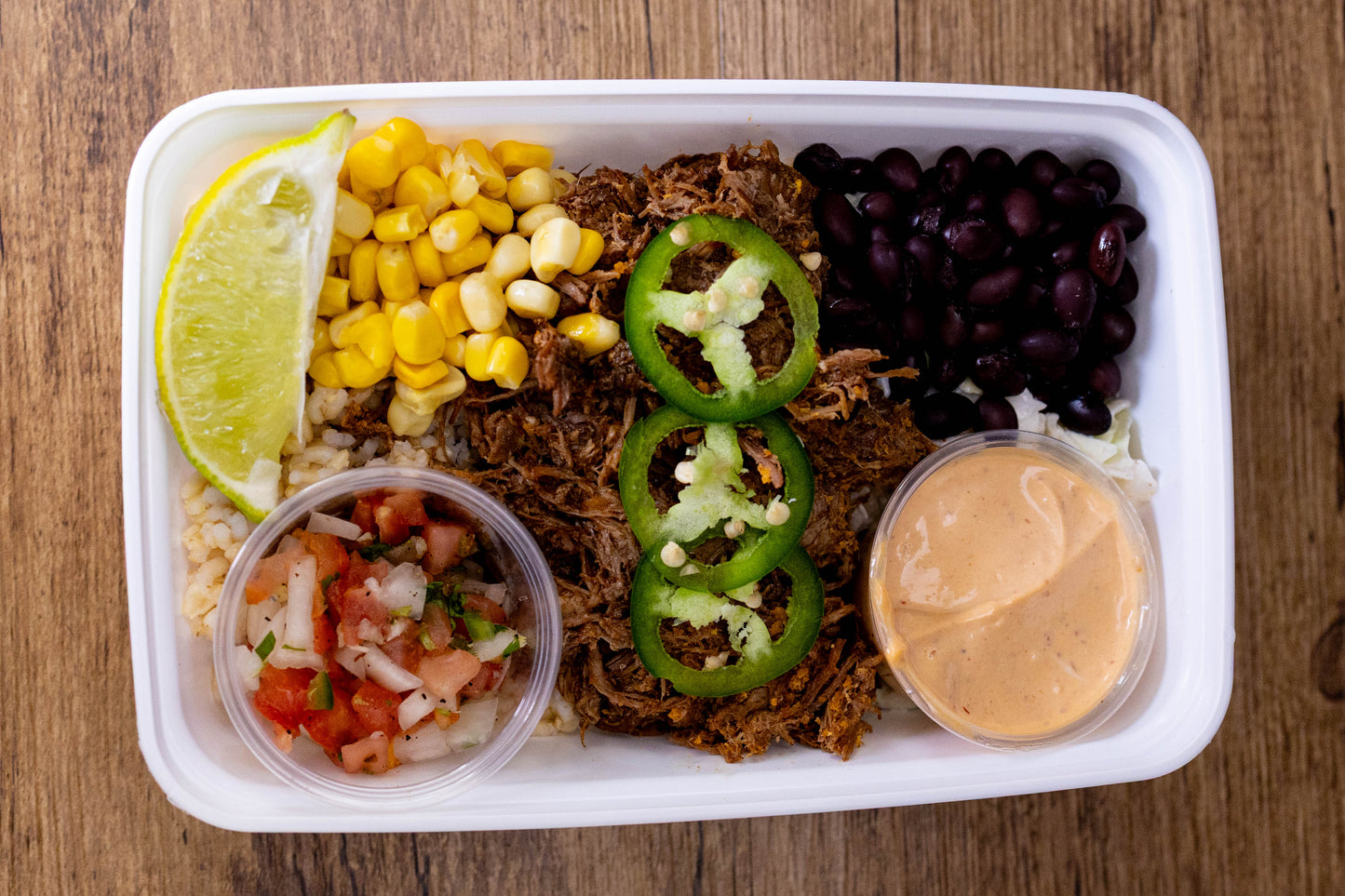 Colourful shredded beef bowl with black beans, corn, and fresh jalapeños, perfect for easy meal planning.